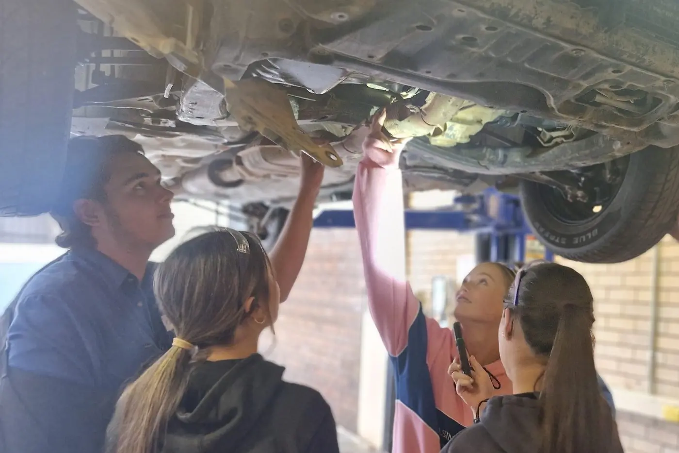 Students engaged in hands-on automotive tasks as part of their Try a Trade program last week.