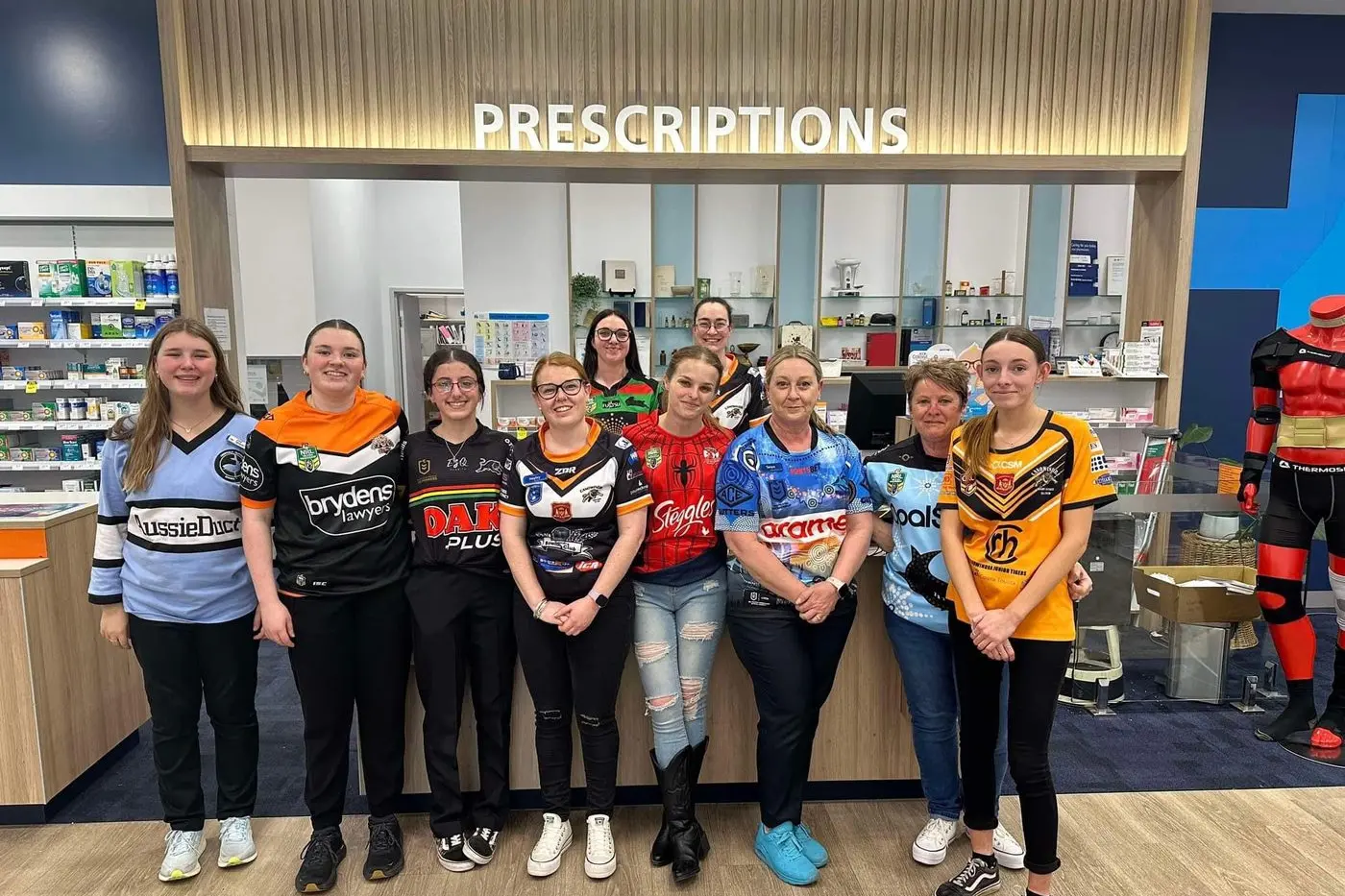 SUPPORTING TEAMS AND CAUSES: Optimal Pharmacy staff were all kitted out in their jerseys last week to raise awareness for organ donation. Photo supplied.