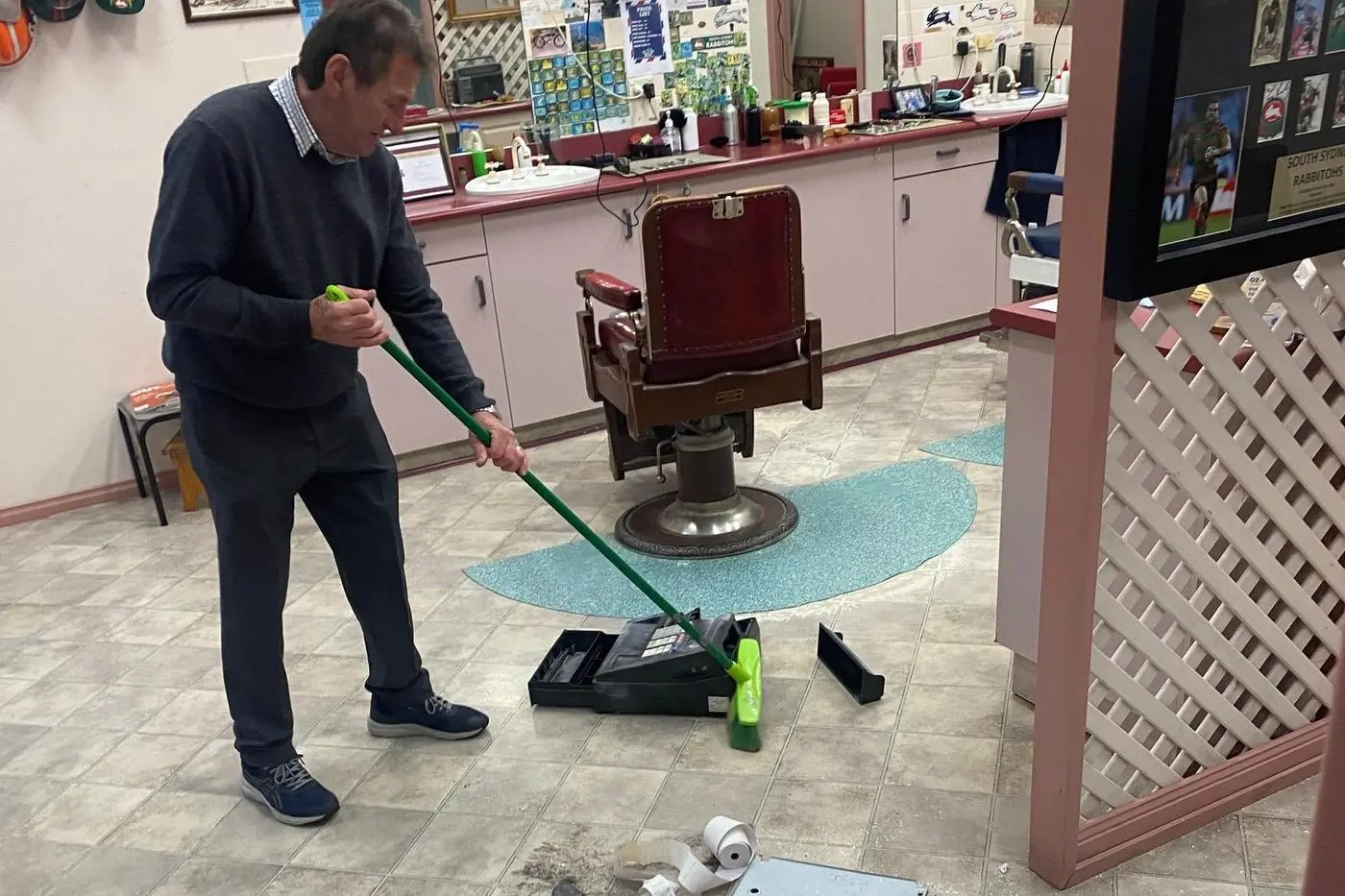 BIG JOB AHEAD: Angelo Lazarou cleaning up the mess left by criminals who went on a warpath through Calare Arcade last weekend. 