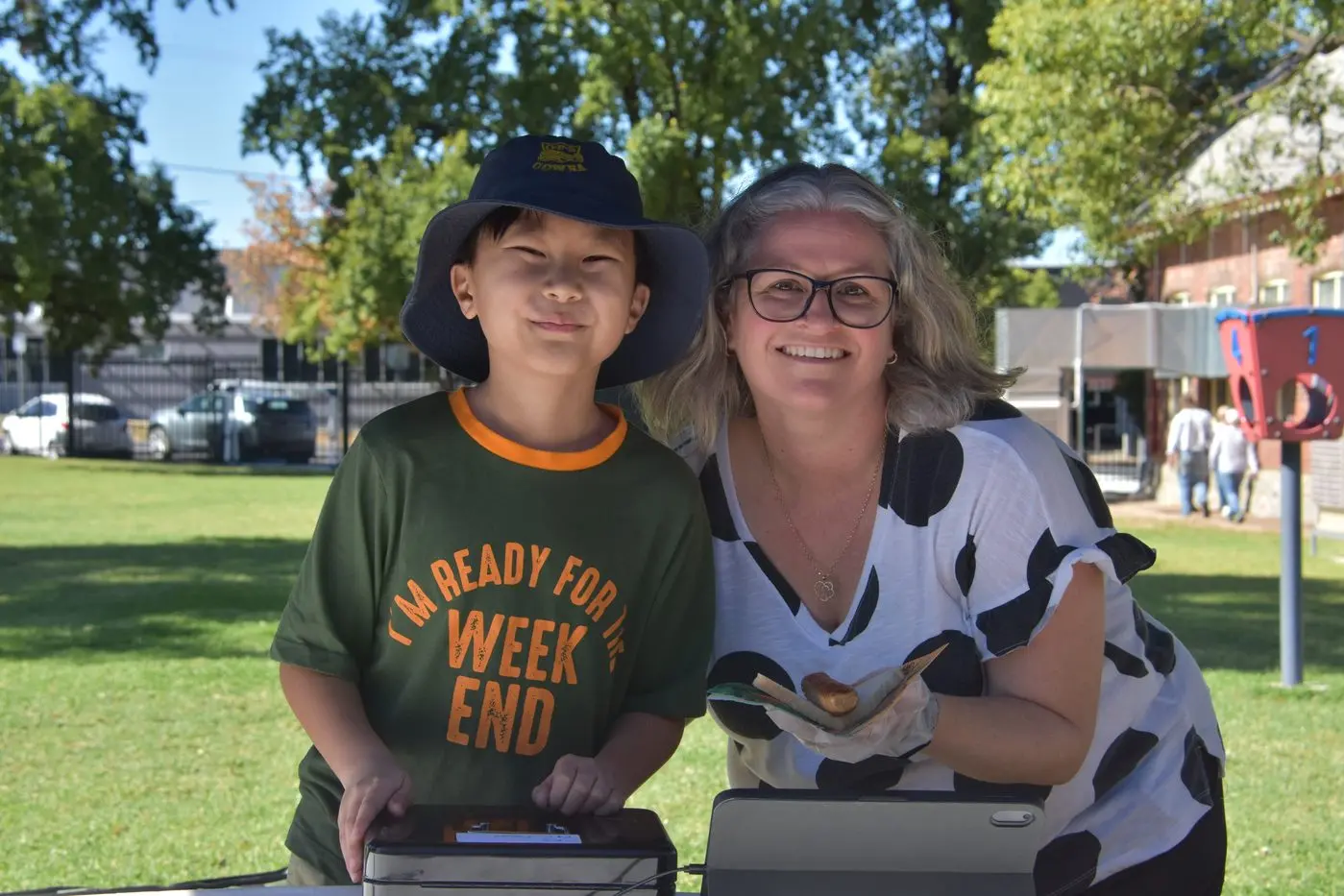 Isaac Lee and Felicity Collins of the Cowra Public School PTA, keeping voters well acquainted with the tradition of the democracy sausage. Photo: Dan Ryan.