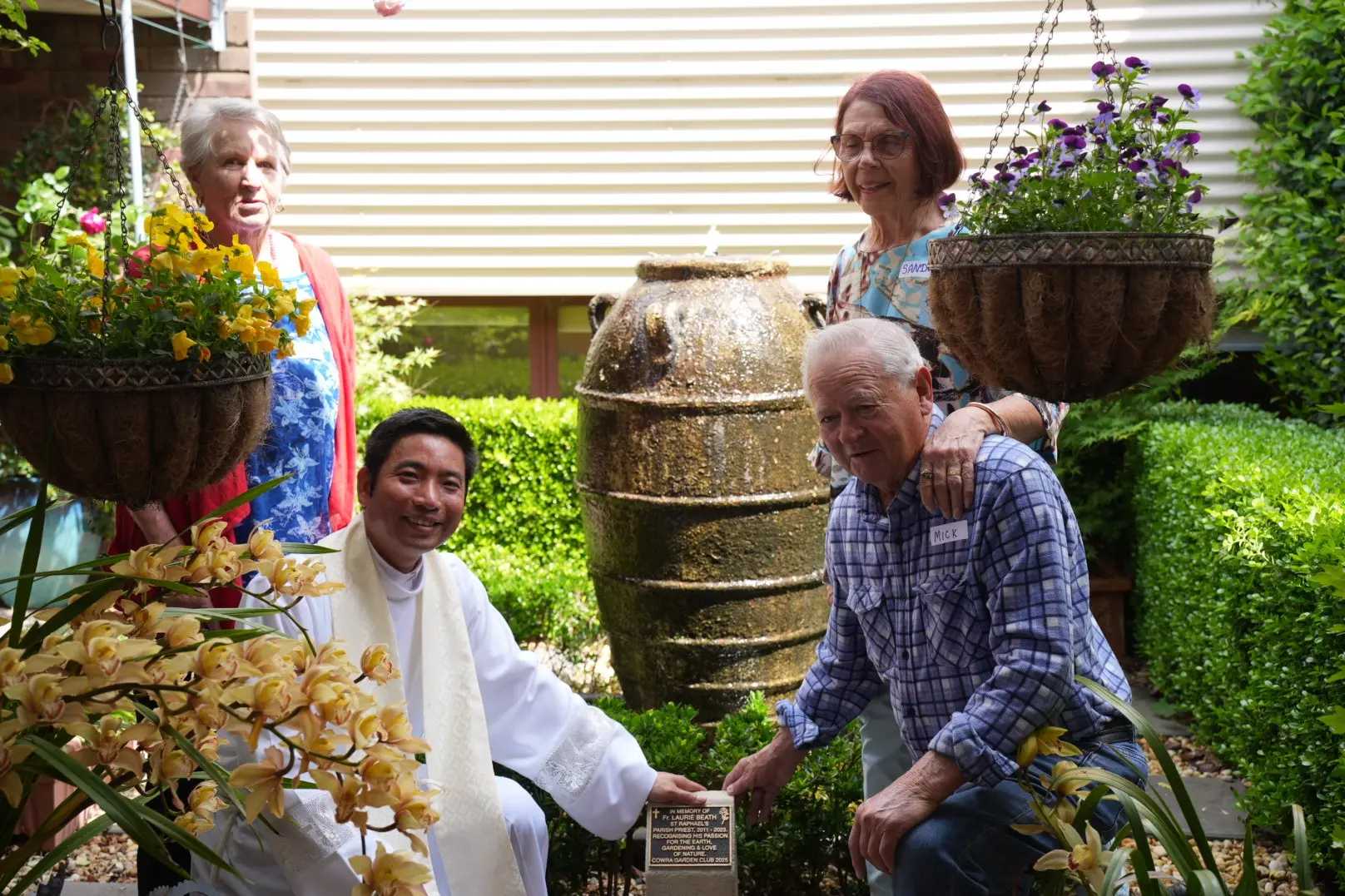<p>Marianne Beath, Sandera and Michael Beath with Father Thao.</p>\\n