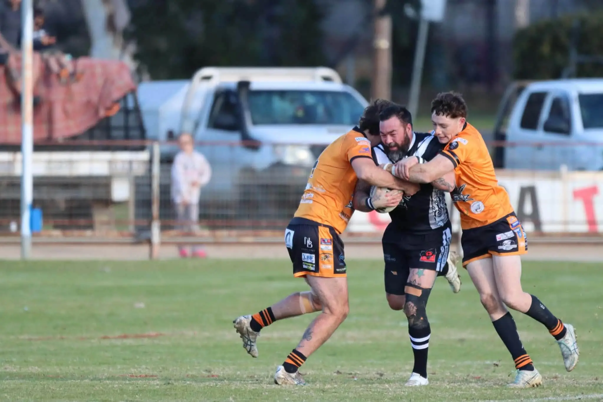 <p>Dave Doran from the Cowra Magpies powering through Canowindra Tigers defenders</p>\\n