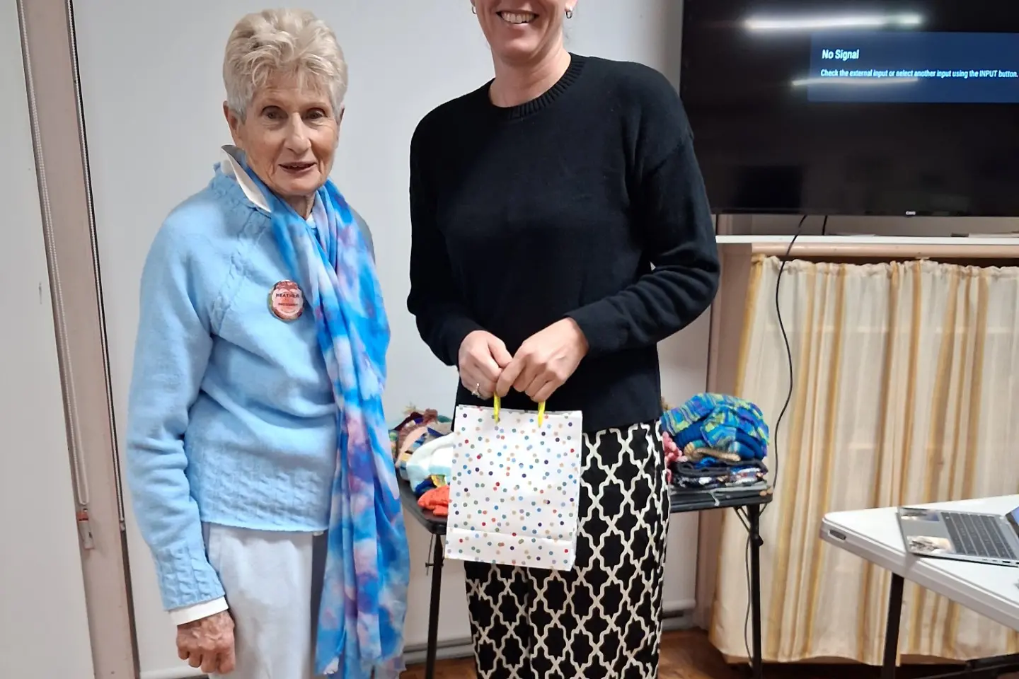 <p>(L) President Heather Kiely gave a gift of appreciation to guest speaker Monica Langfield.</p>\\n