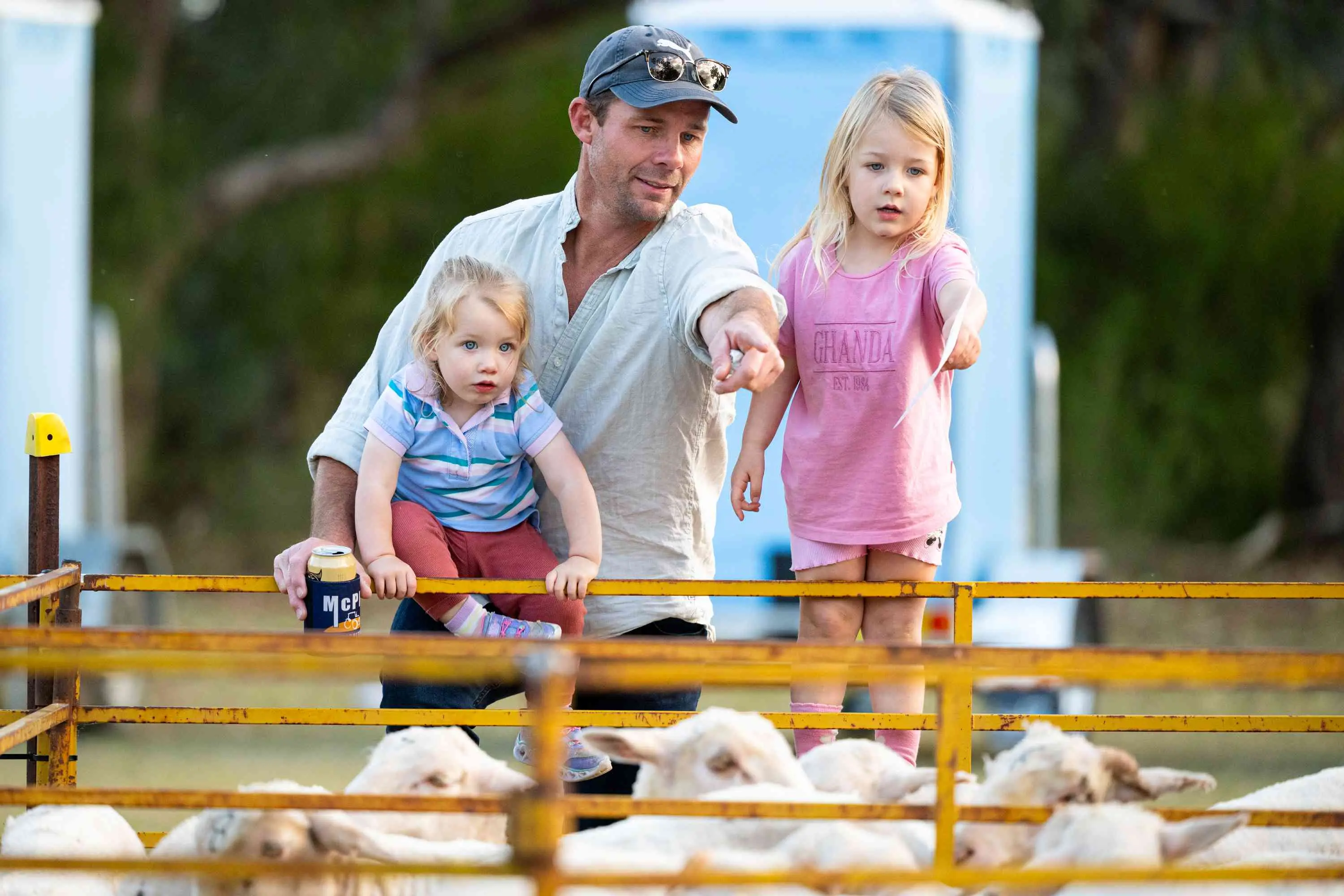 <p>Ash McMahon of Parkes with his daughters enjoying the Caragabal Sheep Races. PHOTOS: Stuart Walmsley </p>\\n