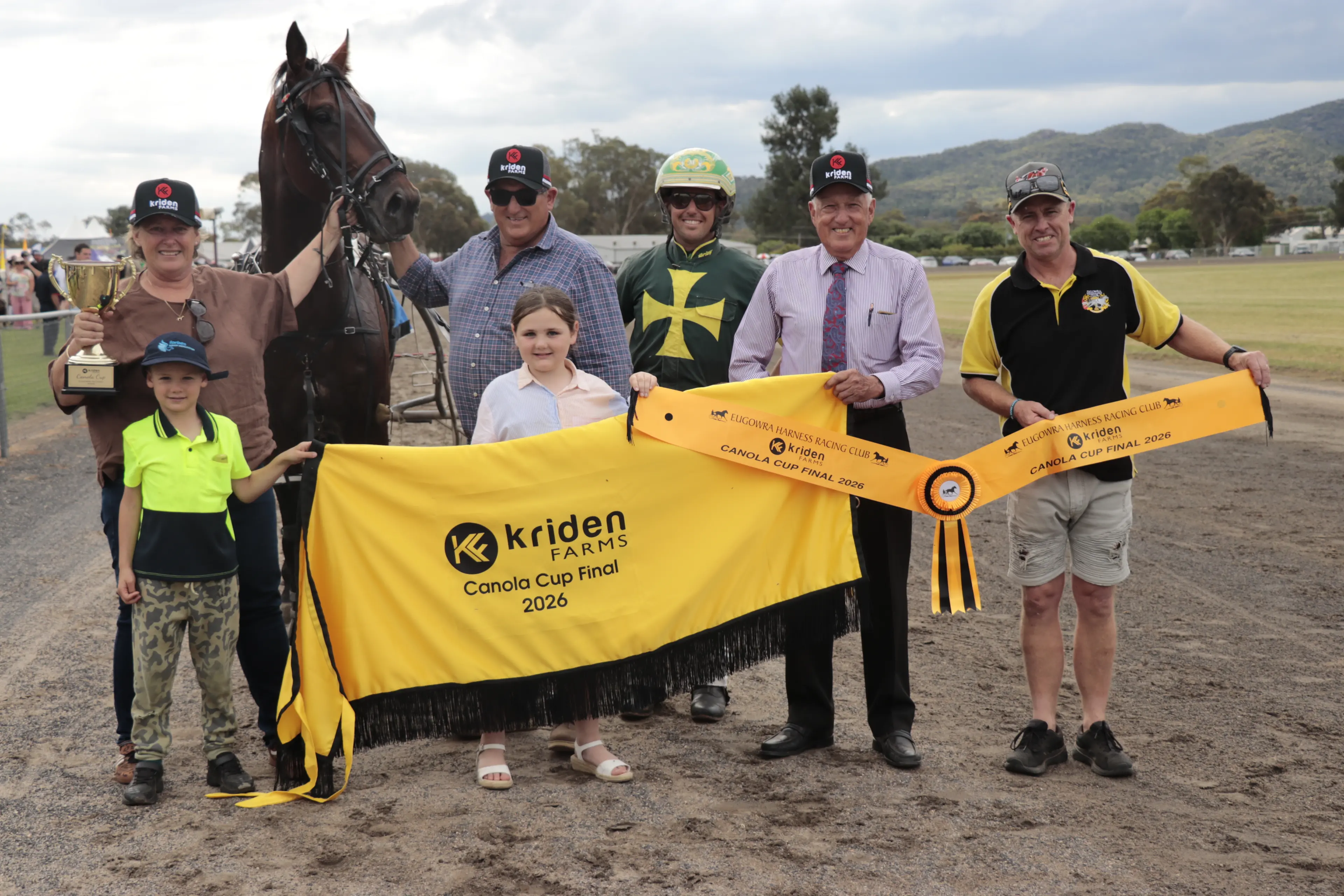 <p>Rod Smith from Kriden Farms and Ben Greenhalgh from Eugowra Harness Racing Club congratulate winning connections Rachael and David Micallef, driver Blake Micallef, with Beau Grace and Ashleigh Micallef. </p>\\n